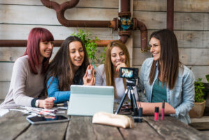 group of four ladies interacting on a live video for social media engagement within their content marketing strategy